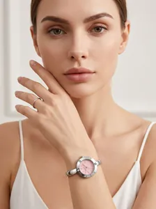 Elegant women's silver-tone bangle watch with pink dial and Roman numerals