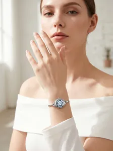 Elegant silver bangle watch with blue round dial worn by a woman for a commuter look