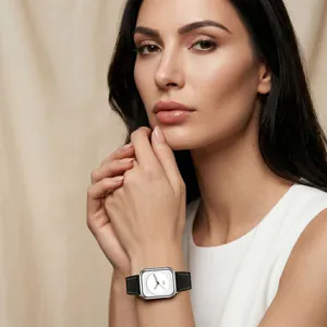 Elegant square quartz watch with black leather strap on female model wrist