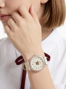 Close-up of children's cartoon bear watch with beige silicone strap and clear case