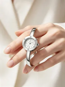 Detailed view of Gedi silver bangle watch with rhinestone bezel and Roman numerals