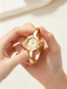Close-up of elegant gold bangle watch with Roman numeral dial and inlaid rhinestones
