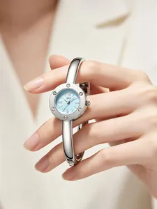 Close-up of a silver bangle watch with light blue dial and Roman numerals