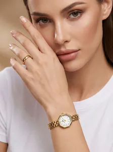 Detail view of a luxury gold octagonal watch with an elegant steel strap