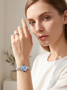 Elegant silver-toned women's quartz watch with a blue mother-of-pearl dial on wrist
