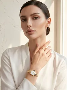 Detailed shot of gold ladies quartz watch with mother of pearl dial on model wrist