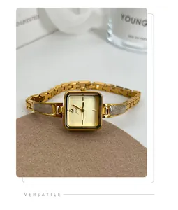 Elegant women's square quartz watch with gold link bracelet and grey stone accents