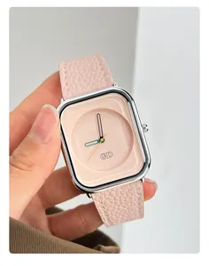 Close-up of minimalist square watch with pink leather strap and silver case