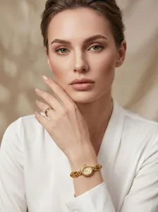 Close-up of GEDI vintage gold bracelet watch with amber stones worn by a model.