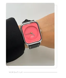 Close-up view of a minimalist women's rectangular quartz watch with a vibrant pink dial.