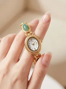 Close-up of GEDI vintage oval women's watch with green jade bracelet and diamond dial