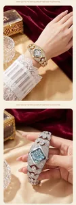 Detailed view of luxury diamond-encrusted women's quartz watch in gold and silver finish