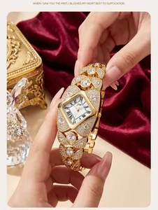 Close-up of a gold luxury women's quartz watch encrusted with sparkling rhinestones