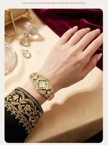 Detail of a luxurious gold-tone rhinestone bracelet quartz watch worn on an elegant wrist