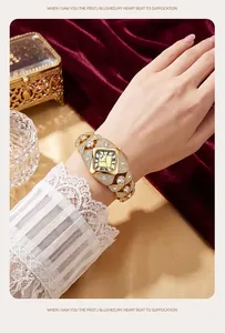 Detailed view of luxury gold-tone bangle watch with sparkling rhinestone embellishments