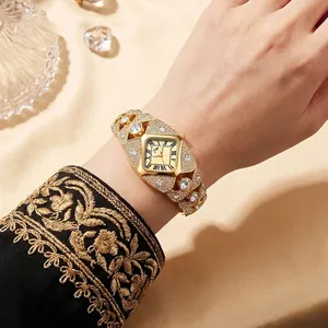 Luxurious gold-tone bracelet watch featuring a diamond-encrusted case and square Roman dial.