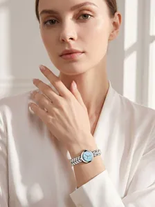 Close-up of elegant ladies quartz watch with light blue pearl dial and silver link bracelet