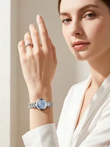Detailed view of an elegant women's silver chain watch with blue MOP dial on wrist