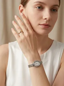 Detail of elegant vintage oval watch with silver chain strap worn on woman's wrist