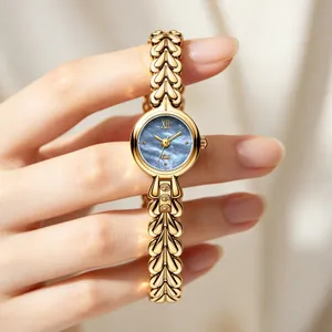 Elegant gold ladies quartz watch with blue mother-of-pearl dial and heart link chain