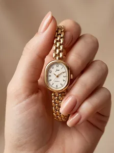 Close-up of a vintage gold oval quartz watch for women featuring a stylish chain link strap