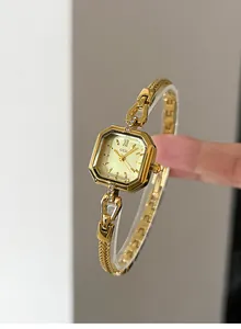 Close-up of elegant gold square watch with vintage GEDI quartz dial and chain band.