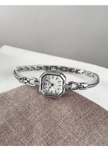 Elegant silver square quartz watch with vintage metal bracelet shown in close-up