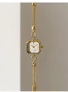Detailed close-up of a vintage gold square quartz watch with GEDI brand on white dial
