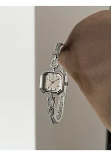 Vintage elegant silver women's square quartz watch with refined metal strap detail.