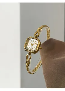 Detailed view of an elegant gold square alloy watch with small crystal accents