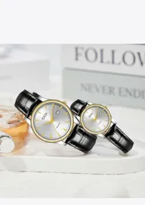 Detailed view of minimalist couple quartz watches with black leather straps and date display