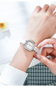 Elegant GEDI vintage small square watch with white leather strap shown worn on a lady's wrist.