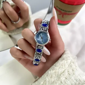Close-up detail of GEDI vintage ethnic style women's bangle watch with blue stones