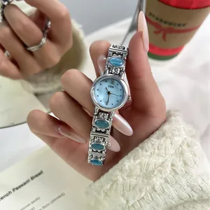 Close-up of a vintage ethnic style silver women's watch with blue stones and light blue dial