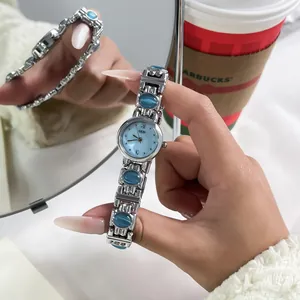 Close-up of GEDI vintage ethnic style watch with blue stones and silver bangle strap