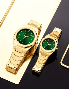 Detalle de relojes de pareja dorados con esferas verde oscuro y bisel octogonal
