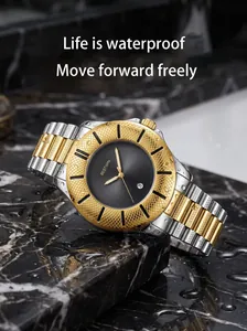 Detailed macro view of gold and silver quartz watch with waterproof droplets on black dial