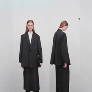 Detailed look at a minimalist black wool oversized blazer and wide-leg trousers set.