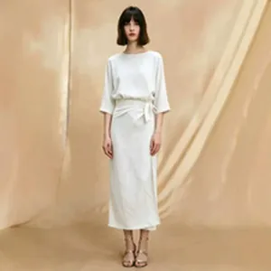 Elegant white midi dress with waist tie and loose fit, professional model photoshoot detail