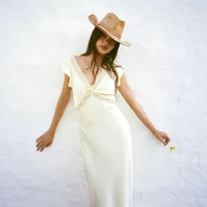 Elegant cream V-neck lace maxi dress with straw cowboy hat for summer vacation style