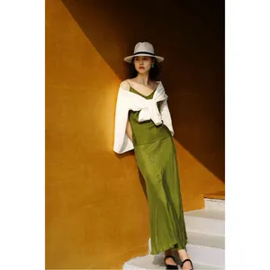 Elegant summer outfit featuring green cupro camisole and matching fishtail maxi skirt