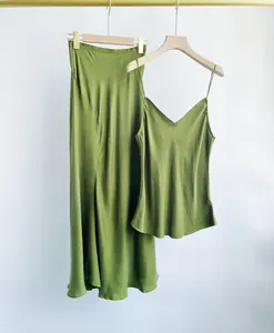 Elegant olive green sand-washed cupro silk camisole and midi fishtail skirt set on hangers