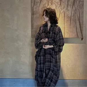 Elegant purple plaid lightweight sunscreen jacket worn by model in artistic indoor setting