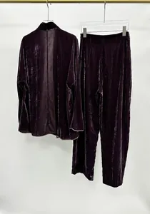 Detailed view of luxury purple velvet suit set showing the glossy fabric texture.