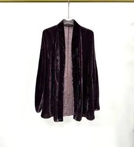 Detail shot of a dark purple velvet collarless cardigan showing rich fabric texture