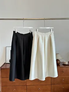 High-quality silk wool blend pleated A-line skirt in black and off-white macadamia color.