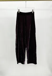 Front view of elegant dark purple crushed velvet wide-leg trousers displayed on a hanger.