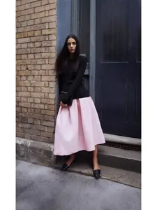 Elegant pleated A-line silk-wool blend midi skirt for a sophisticated spring look.