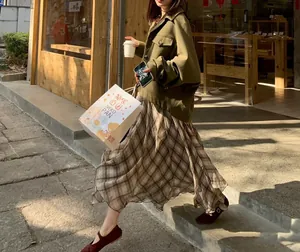 Elegant brown plaid irregular midi skirt with flowing drape for a chic French style