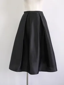 High-end black silk-wool blend A-line pleated midi skirt displayed on mannequin